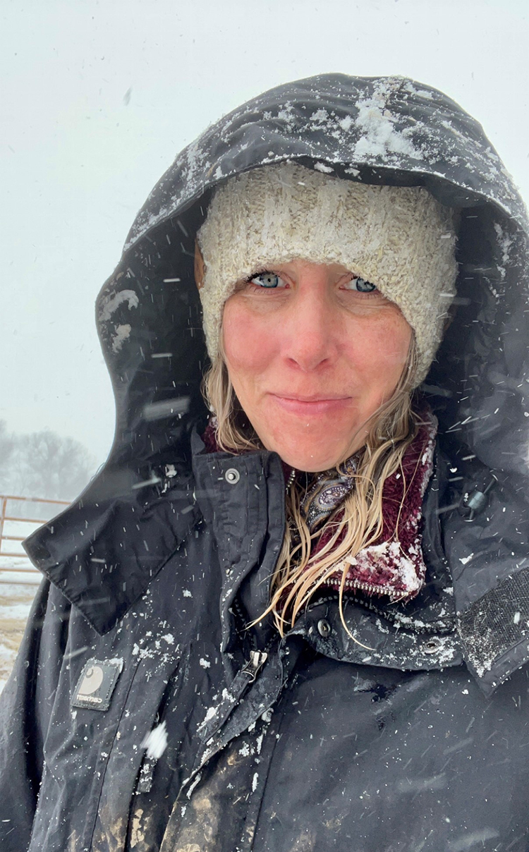The author, checking cows for calves in distress during a blizzard