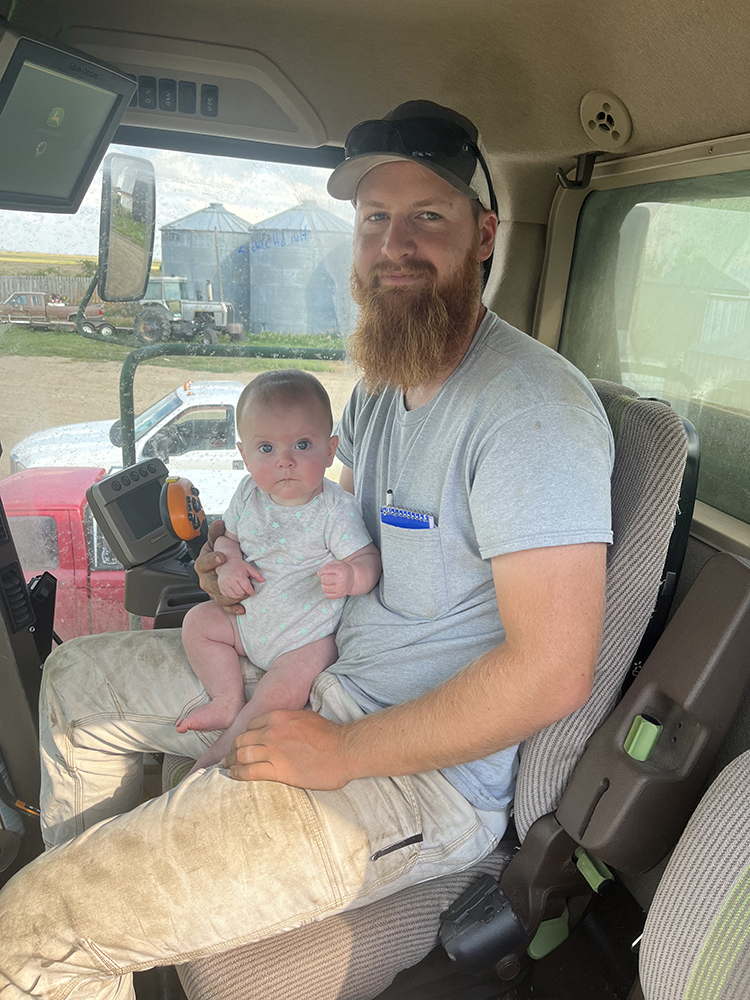 Chance Kitzman and daughter in the tractor