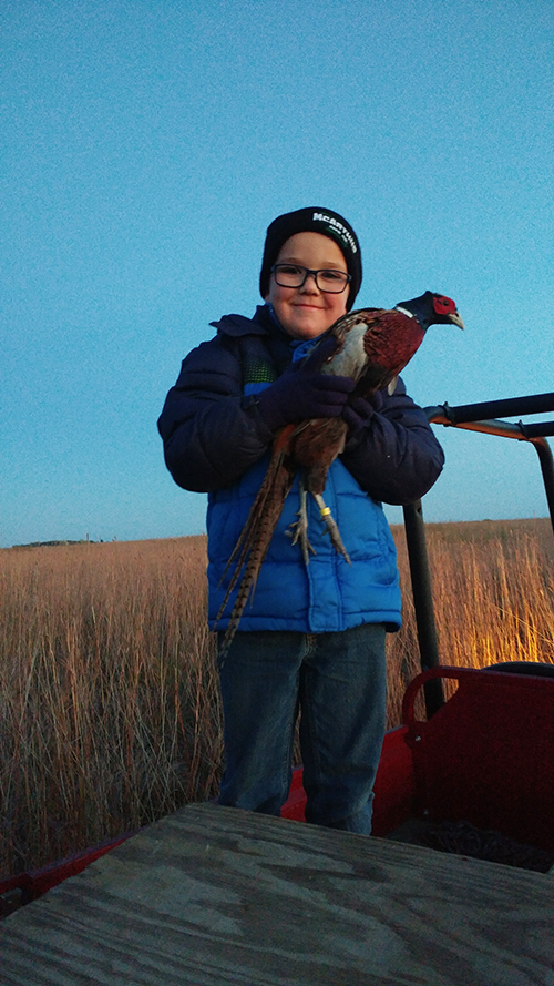 Grayson holding pheasant