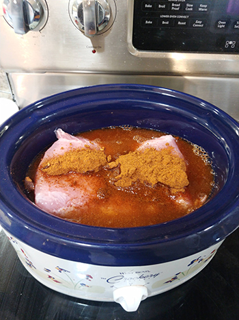 Adding the taco seasoning in the crock pot